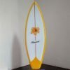 Golden Flower little surfboard model on stone stand